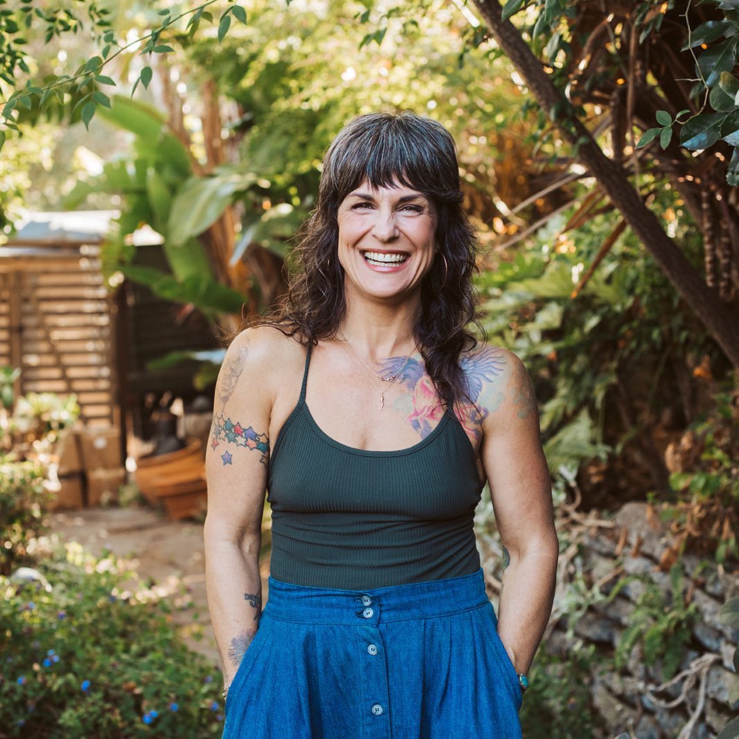 Erika Wright, codependency counselor, smiling in her garden in Sebastopol, California