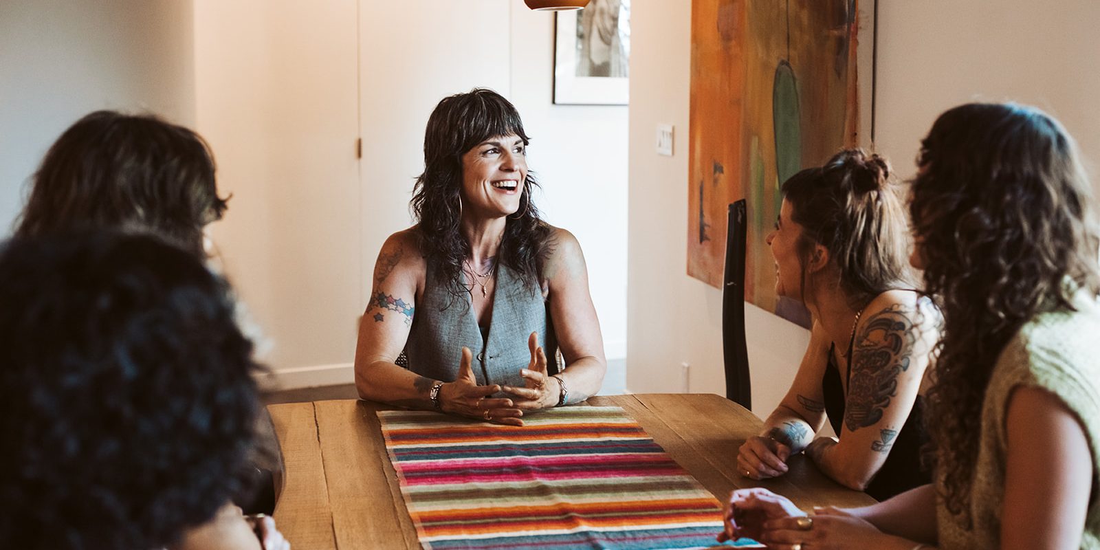 Erika Wright leading a healing codependency group with four women seated around a table